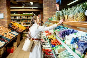 Woman choosing fruits in the supermarket